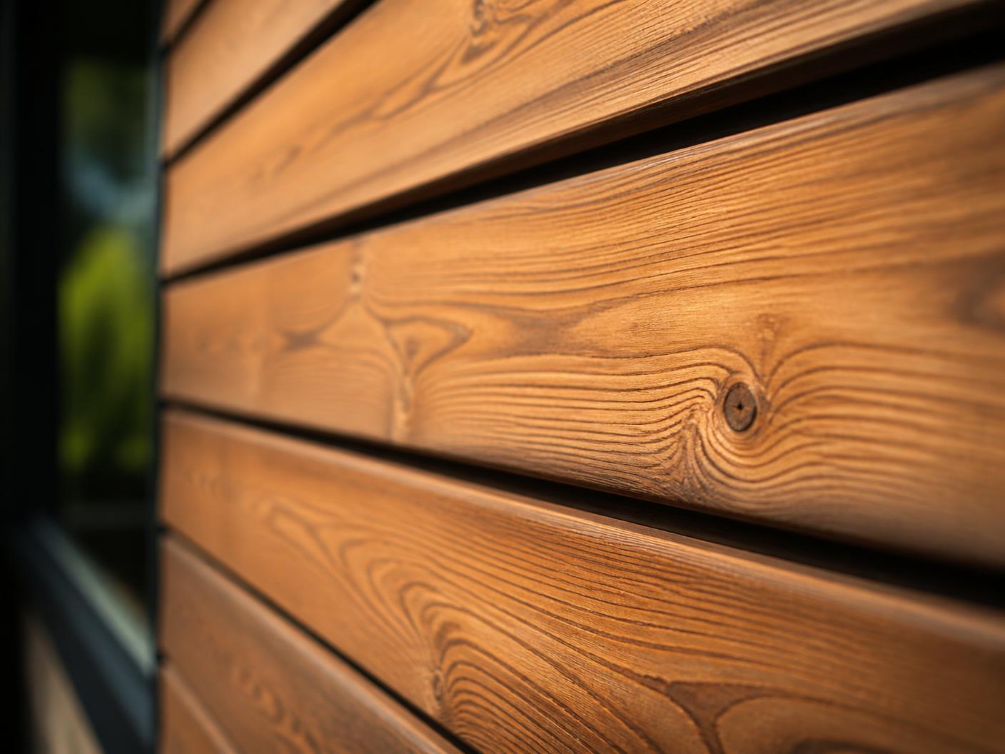Close detail of thermally modified Thermowood cladding on a Glô House sauna